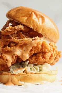 a fried chicken sandwich with cole slaw and mayonnaise