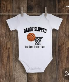 a baby bodysuit that says daddy slipped one past the defense on it's chest