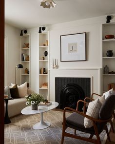 the living room is clean and ready for guests to come home with their belongings on the shelves