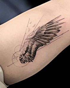 a woman's thigh with an eagle tattoo design on it, and lines in the background