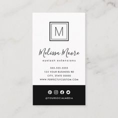 business card with the letter m in black and white, on a marble table top