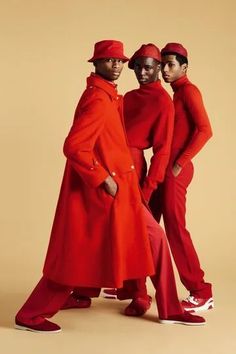 three men in red outfits standing next to each other on a beige background with words written below them