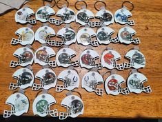 a table topped with lots of football helmets on top of each other and key chains attached to them