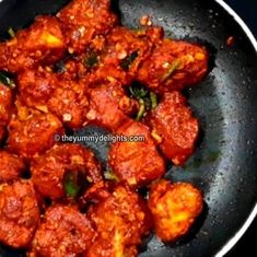 some food is cooking in a frying pan on the stove and ready to be eaten