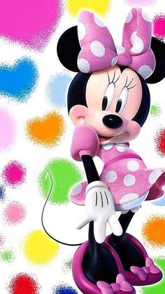 a cartoon minnie mouse with pink polka dots on it's head and holding a white object in her hand