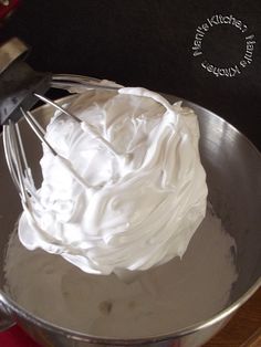 whipped cream in a metal bowl with a whisk