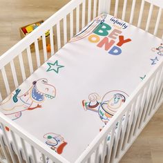 a baby crib bedding set with an image of cartoon characters printed on it