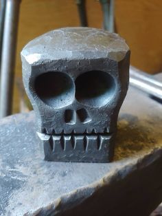 a cement skull sitting on top of a table