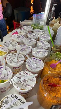 a table filled with bowls and containers of food