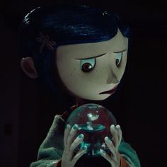 a creepy doll holding a glass ball in her hands