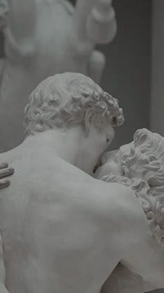 a statue of two men embracing each other