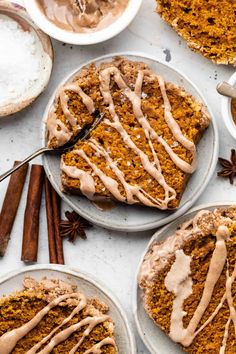 slices of pumpkin spice bundt cake on plates with cinnamon sticks and anisette drizzle