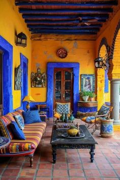 an outdoor living room with blue and yellow walls