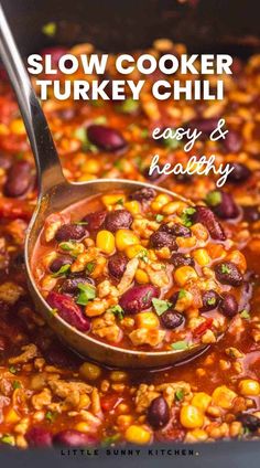 slow cooker turkey chili in a pot with a ladle full of beans and corn