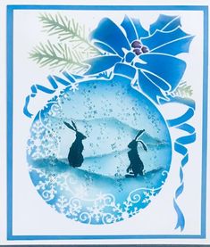 a blue and white christmas card with two rabbits