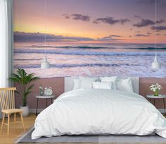 a bedroom scene with the ocean in the background and a wall mural on the wall