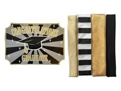 a black and white striped book with congratulations graduate patch on the front, and a gold foiled graduation pin