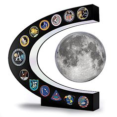 the moon is on top of a black and white plaque with many different emblems