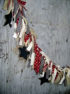 an old wooden wall with stars and ribbons hanging from it's sides on the side