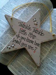 a wooden star ornament that says twinkle little star do you know how loved you are?