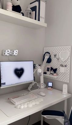 a white desk with a computer monitor and keyboard