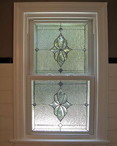 two stained glass windows in a bathroom