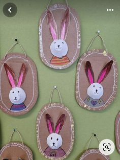 some bunny ears hanging on the wall with other decorations in front of them that are made out of paper