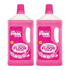 two bottles of pink stuff sitting next to each other