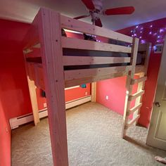 there is a bunk bed in the room with pink walls and carpeted flooring