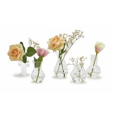 four vases with flowers in them on a white background