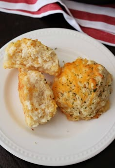 three biscuits are sitting on a white plate