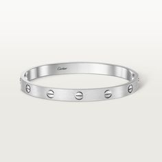 Cartier - LOVE Bracelet, Brushed Finish - Bracelet White gold/Gold - LOVE bracelet, white gold 750/1000, brushed finish. Comes with a screwdriver. Width: 6.1 mm. Created in New York in 1969, the LOVE bracelet is a jewelry design icon: a close fitting, oval bracelet composed of two rigid arcs, which is worn on the wrist and removed using a special screwdriver. The closure is designed with two functional screws placed on either side of the bracelet: you will need help to open or close it. To deter Oval Bracelet, Bracelet White Gold, Lovers Bracelet, Bracelet Love, Love Bracelet, Design Icon, Jewelry Lookbook, Timeless Jewelry, Boutique Online