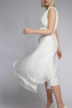 White Dress in Roman Style with Ties Immerse yourself in an atmosphere of refined elegance with this stunning white dress in Roman style. Crafted from lightweight, flowing fabric, it perfectly contours the figure, creating an airy and romantic silhouette. The ties accentuating the waist add a touch of modernity and originality. The fabric drapes beautifully, cascading along the silhouette to provide layers and volume. The midi length makes this dress a versatile choice -- it is perfect for both evening outings and daytime strolls, complementing various heel heights. The pure white color symbolizes freshness and impeccable style, while the loose fit ensures comfort year-round. Pair it with delicate accessories and footwear for a complete look. This dress is your key to impeccable style and Roman Style Dresses, Roman Fashion, Dress With Tie, Draped Fabric, Midi Length, Dress Clothes For Women, White Dress, Loose Fitting, Fashion Dresses