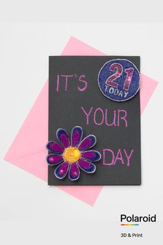 it's your day greeting card with purple and yellow flower on black paper, next to pink envelope