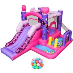 an inflatable bouncy castle with slide and balls