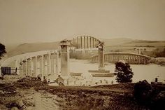 an old black and white photo of a bridge