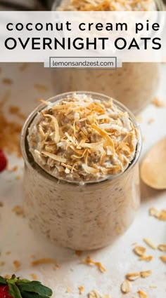 two jars filled with overnight oats and topped with shredded cheese on top, next to strawberries