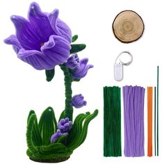 a purple flower with green stems and other items to make it look like an artificial plant