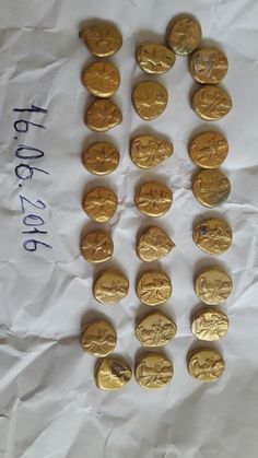 a bunch of gold coins sitting on top of a white sheet