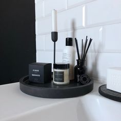 a bathroom counter with candles, soap and other items on it