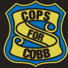 the cops for corb logo is shown in blue and yellow on a black background