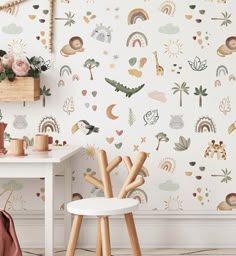 the wallpaper in this room is decorated with animals, trees and rainbows on it