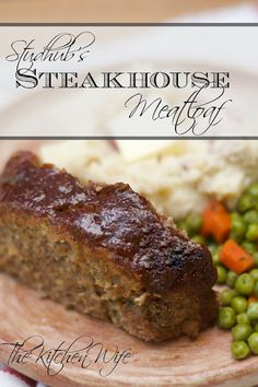 a plate with meatloaf, peas and mashed potatoes