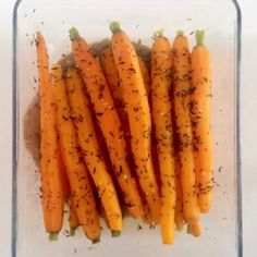 carrots with herbs in a glass dish on a table