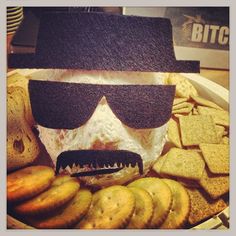 a plate with cookies and crackers in the shape of a skull wearing sunglasses on top of it