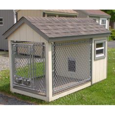 a small dog house with a fence around it's door and windows on the roof