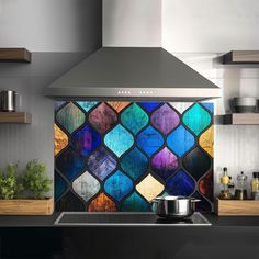 a stove top oven sitting inside of a kitchen under a stained glass wall mounted hood