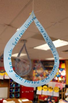 a water drop hanging from the ceiling in a classroom