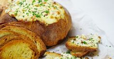 bread with cheese and chives sitting on top of it