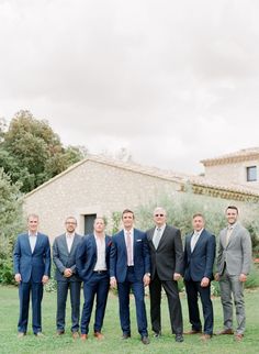 a group of men in suits standing next to each other